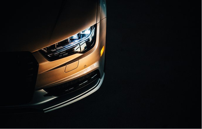 The headlight of a car in the dark