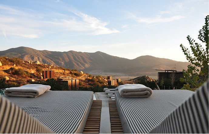 A terrace of sunbeds looking over the hills